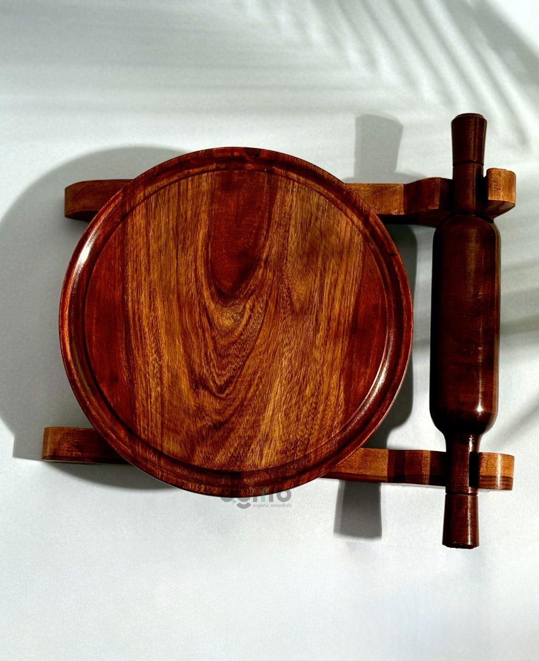 Top view of handcrafted Sheesham wood chakla with belan placed on wooden stand in bright natural light.