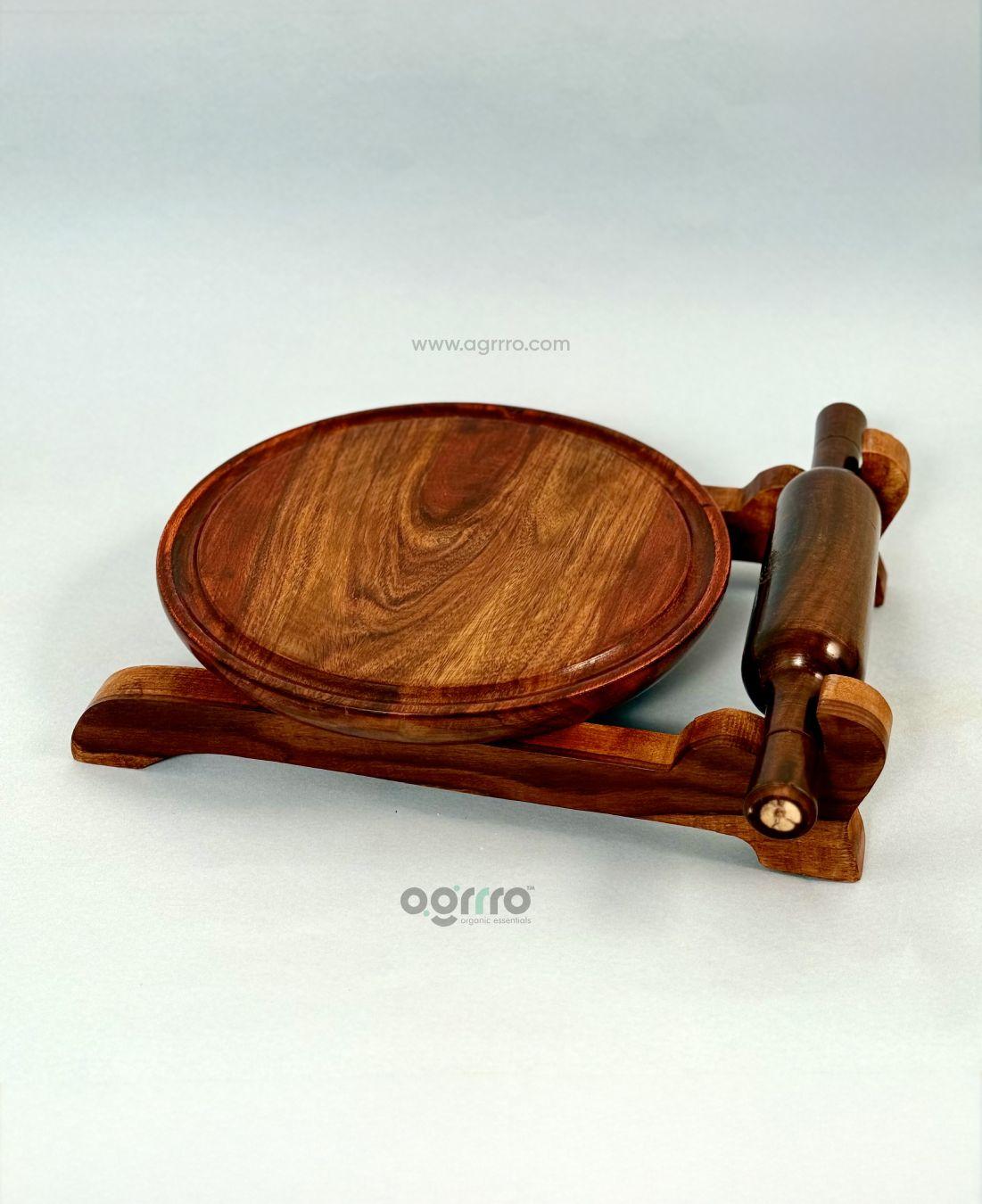 Side angle view of chakla belan set showing elegant curves, deep wood tones, and natural texture on white background.