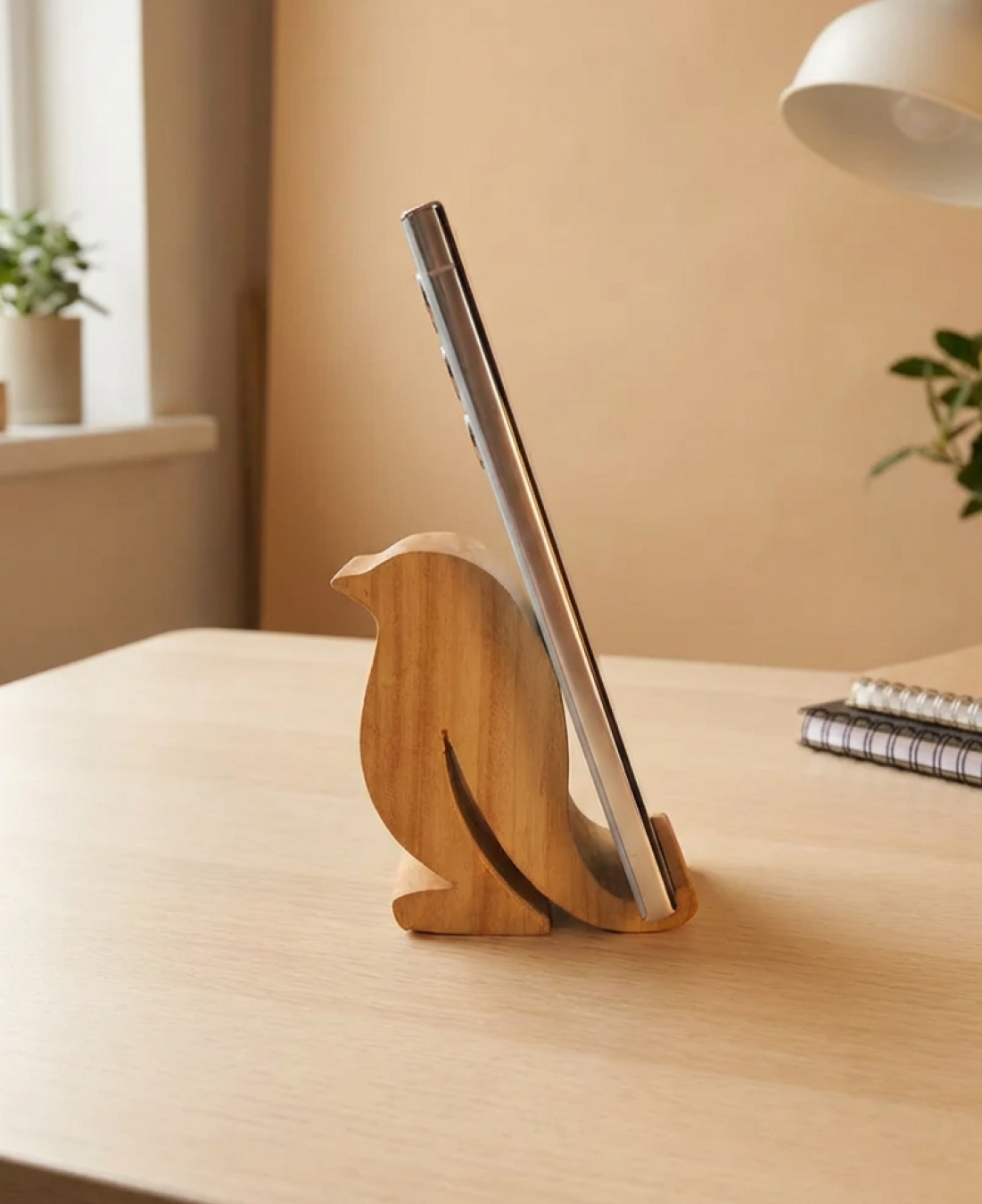A handcrafted wooden bird-shaped phone stand that blends functionality with minimalist decor.